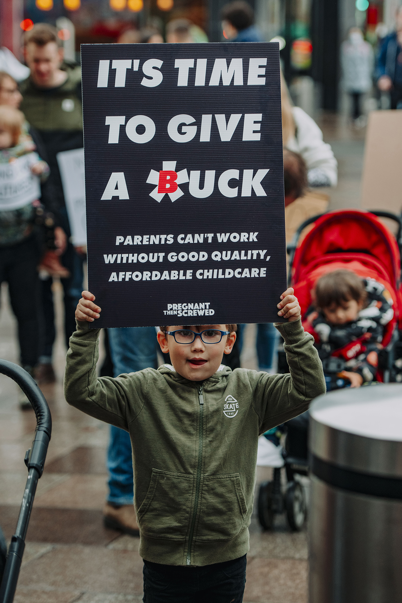 Alt text: Little boy at March of the Mummies protest holding a sign saying 