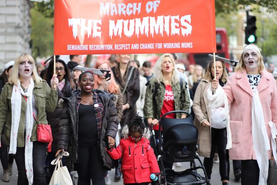 Image description: Women marching in the March of the Mummies protest 