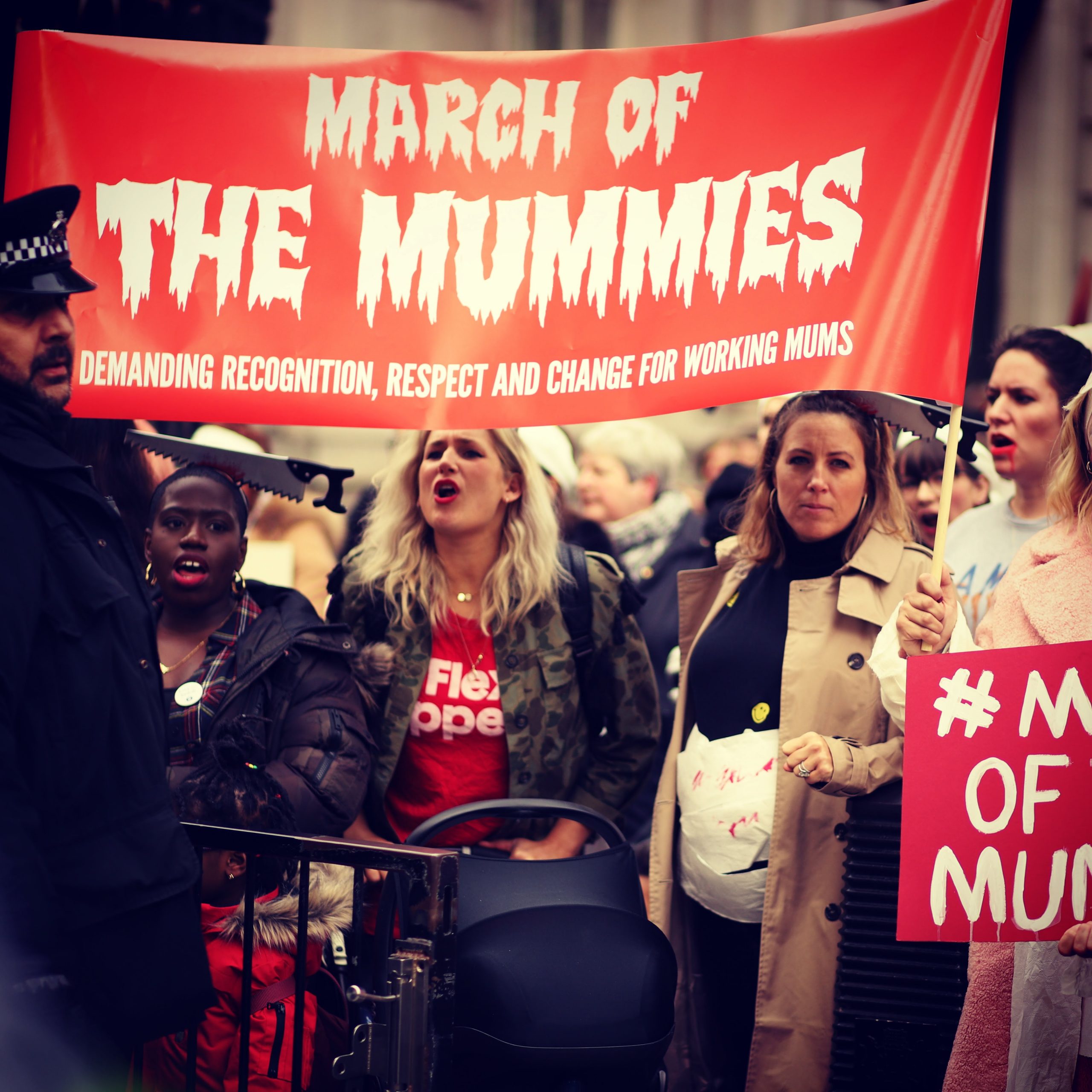 Women protesting with a March of the Mummies banner