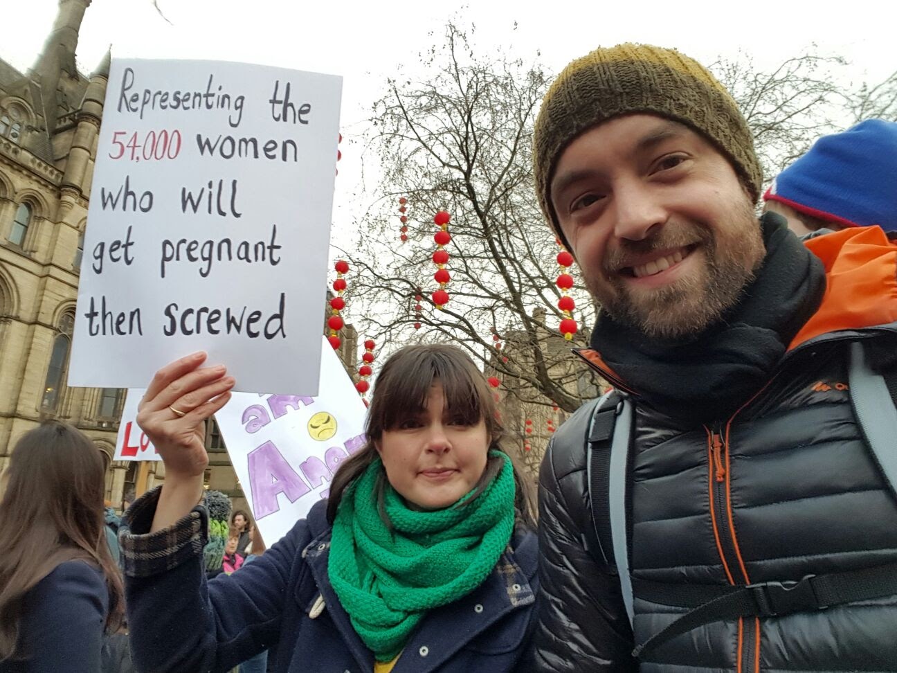 Woman holding a sign that says 'Representing the 54,000 women who will get pregnant then screwed'