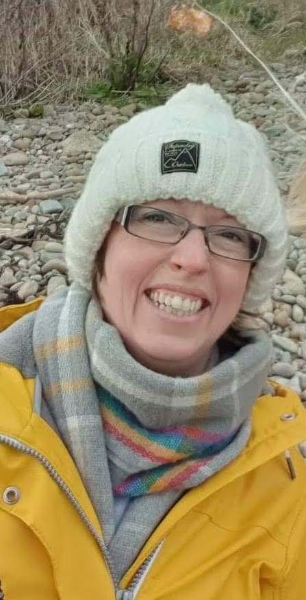 Alt text: Kirsty Morrison smiling wearing a hat and scarf